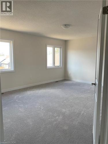 Carpeted spare room with a textured ceiling - 49 Eberhardt Drive, Wasaga Beach, ON - Indoor Photo Showing Other Room