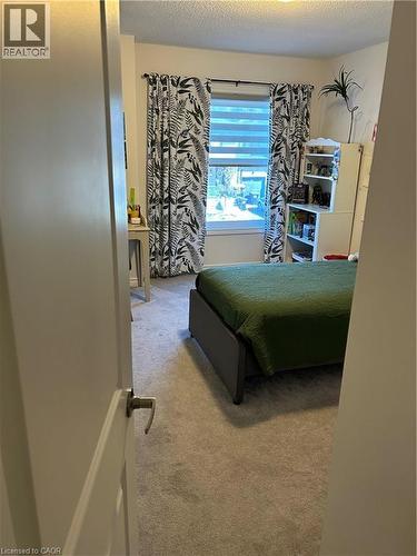Bedroom featuring a textured ceiling and carpet flooring - 49 Eberhardt Drive, Wasaga Beach, ON - Indoor