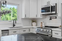 Stainless Steel Appliances with Tile Backsplash. - 