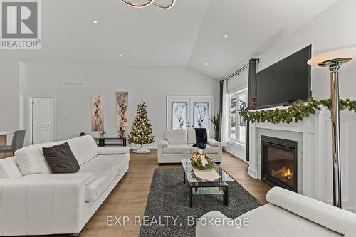 Living Room & Access to the covered porch - 3571 Whispering Woods Trail, Fort Erie (Ridgeway), ON - Indoor Photo Showing Living Room With Fireplace