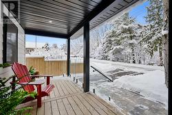 Spacious Front Porch with Glass Railings. - 