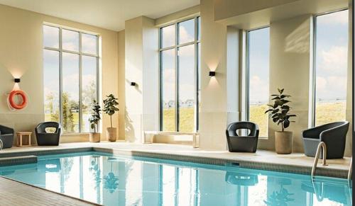 Piscine - 402-4325 Rue Des Dirigeables, Longueuil (Saint-Hubert), QC - Indoor Photo Showing Other Room With In Ground Pool