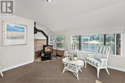 a lovely sunroom with a fireplace insert - 
