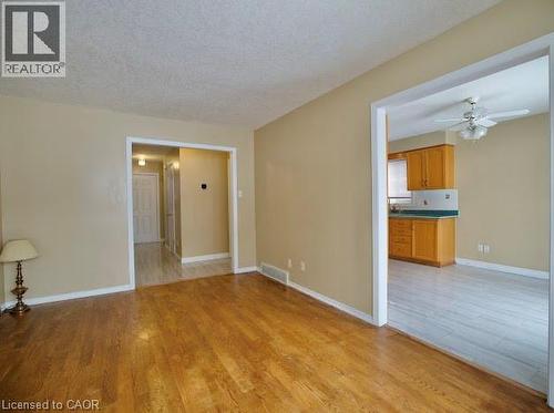Unfurnished living room with light wood-type flooring, a textured ceiling, and a ceiling fan - 109 Beechmanor Crescent, Kitchener, ON - Indoor Photo Showing Other Room