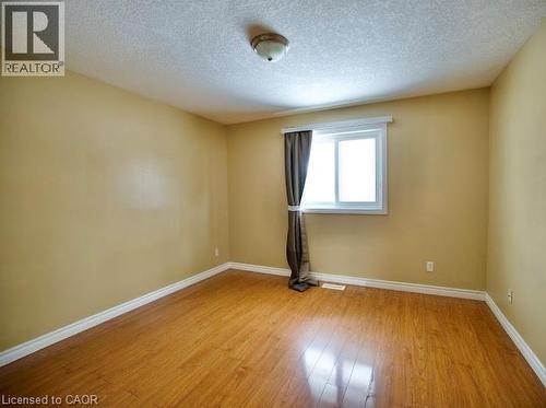 Unfurnished room with light wood-style flooring and a textured ceiling - 109 Beechmanor Crescent, Kitchener, ON - Indoor Photo Showing Other Room
