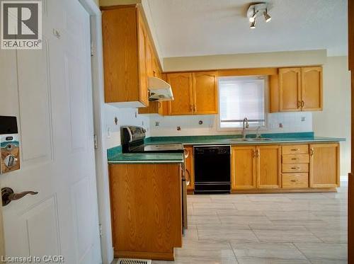 Kitchen with dishwasher, stainless steel range with electric cooktop, under cabinet range hood, and tasteful backsplash - 109 Beechmanor Crescent, Kitchener, ON - Indoor Photo Showing Kitchen