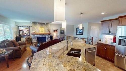 50-1401 30Th Avenue, Cranbrook, BC - Indoor Photo Showing Kitchen With Fireplace With Double Sink With Upgraded Kitchen