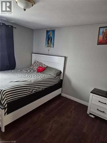 Bedroom featuring baseboards and dark wood finished floors - 76 Brybeck Crescent Unit# 204, Kitchener, ON - Indoor Photo Showing Bedroom