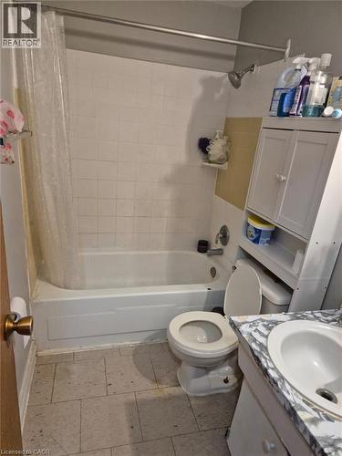 Full bath with shower / bath combo with shower curtain, vanity, and light tile patterned floors - 76 Brybeck Crescent Unit# 204, Kitchener, ON - Indoor Photo Showing Bathroom