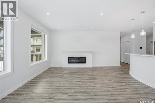 201 3581 Evans Court, Regina, SK - Indoor Photo Showing Living Room With Fireplace