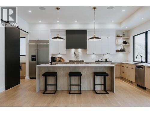 Interior design expertly curated by Isabey Interiors - 5533 Foothill Court, Kelowna, BC - Indoor Photo Showing Kitchen With Upgraded Kitchen