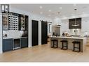 Gorgeous Kitchen & Stylish Bar on main featuring Dekton countertops and backsplash offering unmatched durability and a striking aesthetic. - 5533 Foothill Court, Kelowna, BC  - Indoor Photo Showing Kitchen With Upgraded Kitchen 