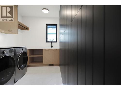Well-designed laundry room with a functional layout and ample storage space - 5533 Foothill Court, Kelowna, BC - Indoor Photo Showing Laundry Room