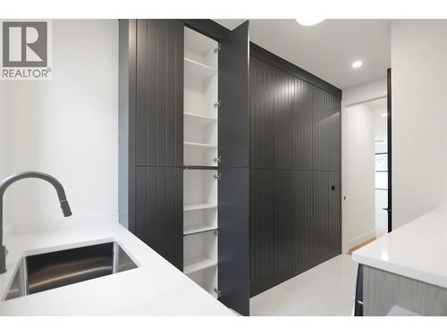 Stylish wall of storage in laundry room - 5533 Foothill Court, Kelowna, BC - Indoor