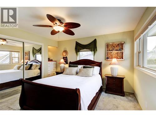 Primary bedroom with closet with access to the patio - 391 Braeloch Road, Kelowna, BC - Indoor Photo Showing Bedroom