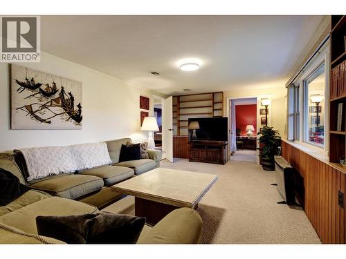 Lower level family room with large window facing front yard. Perfect for a rec room or media room - 391 Braeloch Road, Kelowna, BC - Indoor Photo Showing Living Room