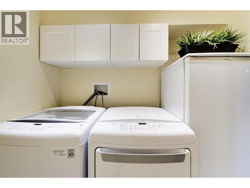 Built in cabinets over washer and dryer - 391 Braeloch Road, Kelowna, BC - Indoor Photo Showing Laundry Room
