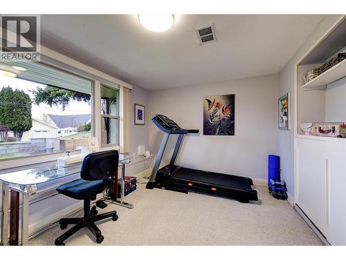 Den with loads of natural light facing the front yard - 391 Braeloch Road, Kelowna, BC - Indoor Photo Showing Gym Room