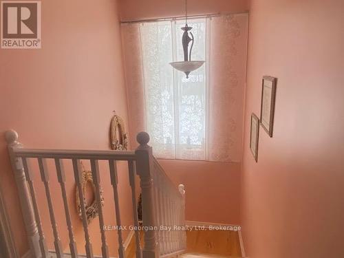 Hall way to second level with Large window - 140 Wolfe Trail Nw, Tiny, ON - Indoor Photo Showing Other Room