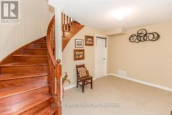 CUSTOM OAK STAIRS OPEN TO BASEMENT LANDING. - 