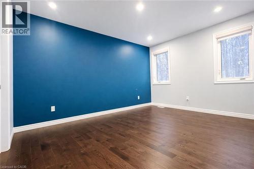 Empty room with dark wood-style floors and recessed lighting - 127 Elmbank Trail Unit# Upper, Kitchener, ON - Indoor Photo Showing Other Room
