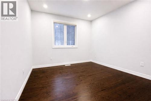 Unfurnished room featuring dark wood finished floors and recessed lighting - 127 Elmbank Trail Unit# Upper, Kitchener, ON - Indoor Photo Showing Other Room