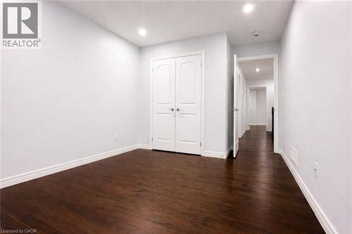 Unfurnished bedroom with dark wood-style floors, recessed lighting, and a closet - 127 Elmbank Trail Unit# Upper, Kitchener, ON - Indoor Photo Showing Other Room