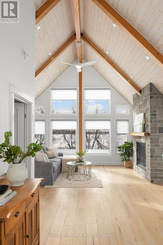 Living room w/ large windows & automatic blinds. - 205 Westar Farm Way, Ottawa, ON - Indoor Photo Showing Other Room With Fireplace