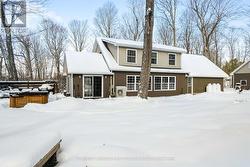Rear view of home with deck and hot tub - 