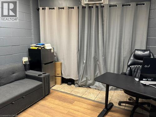 Home office featuring concrete block wall and wood finished floors - 1659 Victoria Street N, Kitchener, ON 