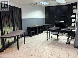 Office space featuring light tile patterned flooring and a paneled ceiling - 