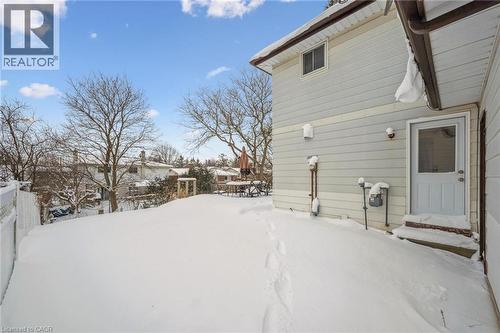 Yard covered in snow featuring a residential view - 21 Forest Glen Court, Kitchener, ON - Outdoor