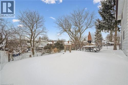 Yard covered in snow featuring a fenced backyard and a residential view - 21 Forest Glen Court, Kitchener, ON - Outdoor With View