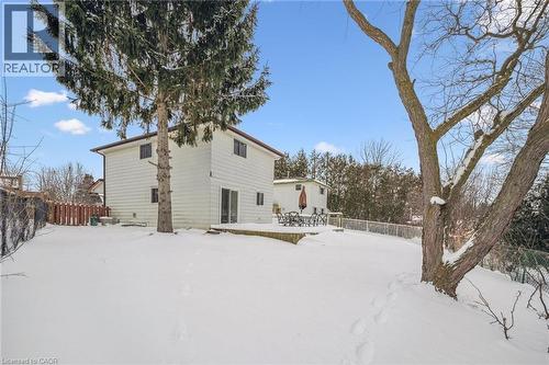 Snow covered rear of property featuring a wooden deck - 21 Forest Glen Court, Kitchener, ON - Outdoor