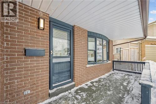 View of exterior entry featuring brick siding and a porch - 21 Forest Glen Court, Kitchener, ON - Outdoor With Deck Patio Veranda With Exterior