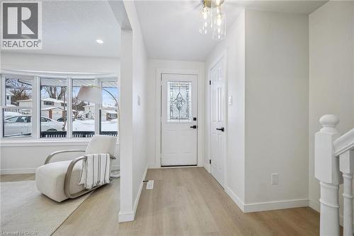 Entrance foyer featuring light wood-style floors, plenty of natural light, and a chandelier - 21 Forest Glen Court, Kitchener, ON - Indoor Photo Showing Other Room