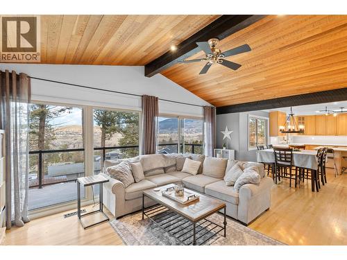 Patio doors leading to top deck - 11609 Upper Summit Drive, Coldstream, BC - Indoor Photo Showing Living Room