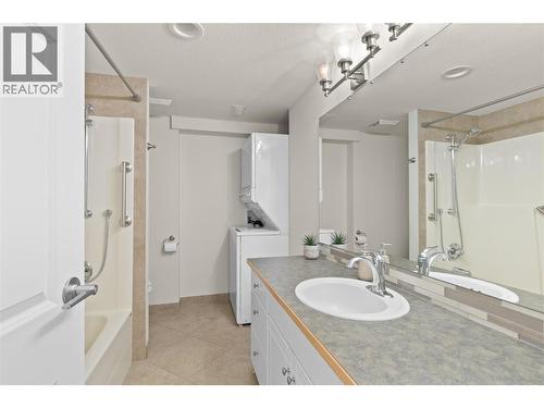 4pc bathroom with laundry in the in-law suite - 11609 Upper Summit Drive, Coldstream, BC - Indoor Photo Showing Bathroom