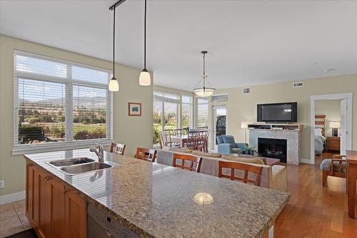301-4205 Gellatly Road, West Kelowna, BC - Indoor Photo Showing Kitchen With Fireplace With Double Sink