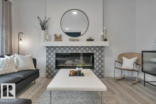 104 Bluff Cv, Leduc, AB - Indoor Photo Showing Living Room With Fireplace