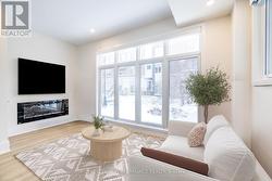 Family room with fireplace and oversized windows - 