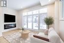 Family room with fireplace and oversized windows - 225 Makadewa Private, Ottawa, ON  - Indoor Photo Showing Living Room With Fireplace 