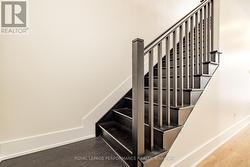 Hardwood stairs to second level and living space - 