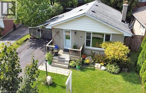 View of front facade featuring brick siding, a wooden deck, and a chimney - 33 Garland Crescent, London, ON - Outdoor With Deck Patio Veranda