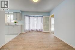Unfurnished dining area with light wood-style flooring and plenty of natural light - 