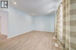 Empty room featuring light wood-type flooring and recessed lighting - 