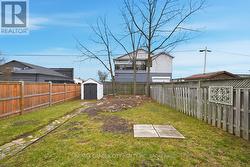Rear yard with gardens. Tree helps provide privacy - 