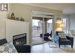 Living room with gas fireplace and access to spacious covered deck. - 