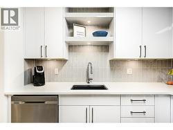 Beautifully updated kitchen with stainless steel appliances and quartz counters - 