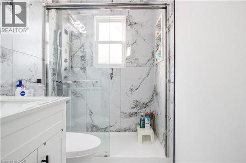 Full bath featuring vanity and a marble finish shower - 773 Queensdale Avenue E, Hamilton, ON - Indoor Photo Showing Bathroom